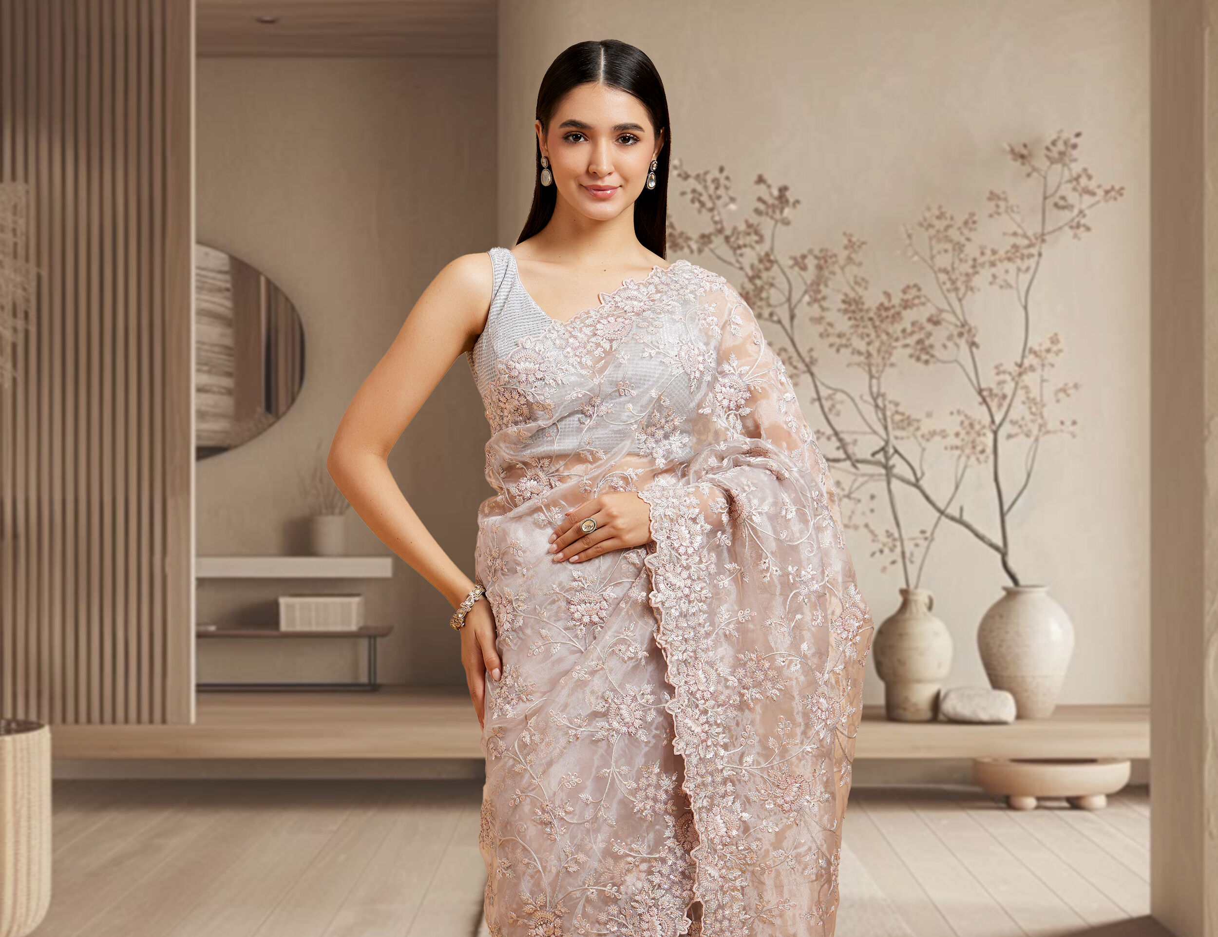 A woman wearing a saree with chunky jewellery and gajra